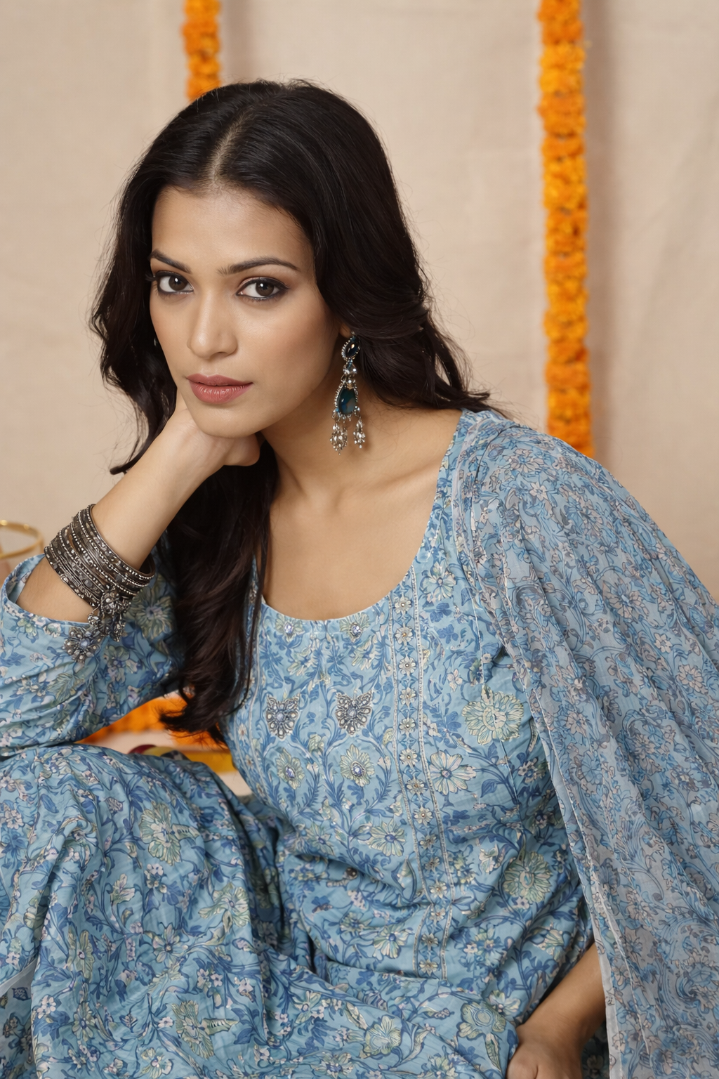 Woman wearing a blue floral dress against a beige background