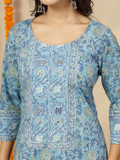 Woman wearing a blue floral patterned top against a neutral background