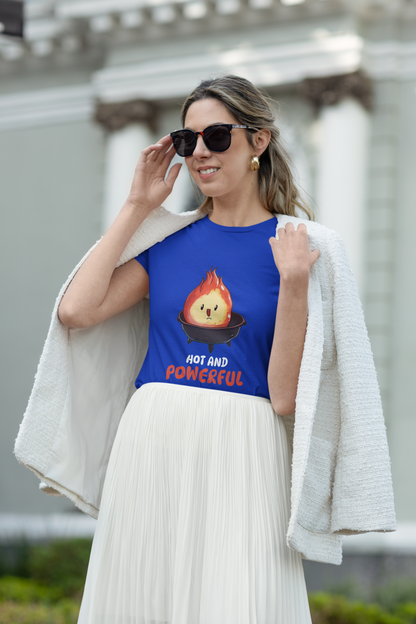 Woman wearing a blue t-shirt with a graphic design and text, standing outdoors.